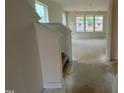 Bright living room under construction that is lined with multiple windows at 107 Willow Cameron Way, Angier, NC 27501