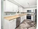 Bright kitchen features granite counters, stainless appliances, and herringbone floors at 108 Boxford Rd, Morrisville, NC 27560