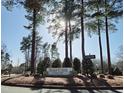 Entrance to Brier Creek Country Club surrounded by tall trees at 11213 Presidio Dr, Raleigh, NC 27617