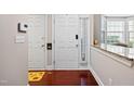 Bright entryway featuring hardwood floors, white door and a granite countertop at 11213 Presidio Dr, Raleigh, NC 27617