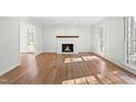 Inviting living room with a cozy fireplace, natural light, and gleaming hardwood floors at 11705 Appaloosa E, Raleigh, NC 27613