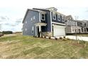 Beautiful new construction home showing the front and side of the yard and stone-lined garage at 136 Willow Cameron Way, Angier, NC 27501