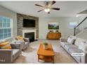 Inviting living room with a fireplace, comfortable seating, and stylish decor at 151 N Great White Way, Clayton, NC 27527