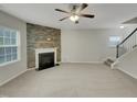 Spacious living room featuring a cozy fireplace and ample natural light at 151 N Great White Way, Clayton, NC 27527