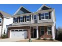 Beautiful two-story home with brick and siding, attached garage, and manicured front yard at 2100 Curry Meadow Way, Durham, NC 27703