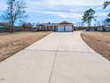 Long concrete driveway leading to a well-maintained brick home, enhancing curb appeal at 2420 New Bethel Church Rd, Garner, NC 27529