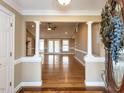 Elegant foyer with hardwood floors, decorative columns, and an open view to the living area at 2420 New Bethel Church Rd, Garner, NC 27529