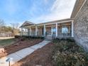 Inviting front porch with classic columns and manicured landscaping, offering a relaxing outdoor space at 2420 New Bethel Church Rd, Garner, NC 27529