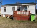 View of back of home with white siding and a wooden porch deck at 305 N State St, Raleigh, NC 27601
