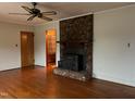 Living room featuring hardwood floors and brick fireplace at 405 N Wilson Ave, Dunn, NC 28334