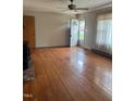 Spacious living room featuring hardwood floors, large windows, and a ceiling fan at 405 N Wilson Ave, Dunn, NC 28334
