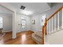 Bright foyer with hardwood floors, staircase, and a charming window for natural light at 5618 Wade Park Blvd, Raleigh, NC 27607