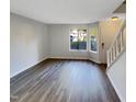 Living room with new paint, hard wood floors, and a large window for natural light at 5850 Shady Grove Cir, Raleigh, NC 27609