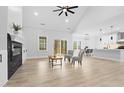 Bright open living area with a fireplace, light-colored floors, and ample natural light from sliding glass doors at 605 Shawnee Dr, Louisburg, NC 27549