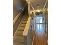 Bright hallway featuring wood floors, stairs, and plenty of natural light at 6520 Thetford Ct, Raleigh, NC 27615