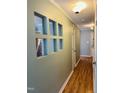 Hallway featuring wood floors and a decorative wall opening to the kitchen at 6520 Thetford Ct, Raleigh, NC 27615