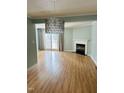 Spacious living room with hardwood floors, fireplace, and sliding glass doors at 6520 Thetford Ct, Raleigh, NC 27615