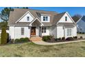 Beautiful white home featuring a welcoming entrance, landscaped yard, and architectural details, creating a charming facade at 654 Christian Light Rd, Fuquay Varina, NC 27526