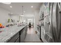 Kitchen featuring a large island with granite countertops and stainless steel appliances at 781 Fireball Ct, Knightdale, NC 27545