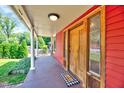 Inviting front porch with wooden door, brick walkway, and classic columns, offering a warm welcome at 807 Vickers Ave, Durham, NC 27701