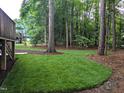 Lush green backyard featuring a wooded perimeter for privacy. Perfect for enjoying nature at 904 Amersham Ln, Wake Forest, NC 27587