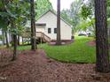 Well-maintained backyard featuring green grass and a wooden deck perfect for outdoor entertaining at 904 Amersham Ln, Wake Forest, NC 27587