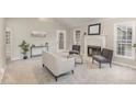 Bright living room featuring a fireplace, neutral color scheme, and ample natural light at 904 Amersham Ln, Wake Forest, NC 27587