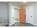 Welcoming foyer showcasing the front door and sleek wood-look floors at 97 Buckstone Pl, Willow Springs, NC 27592