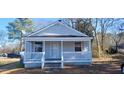 Charming front exterior features a covered porch with white railing and a light gray exterior at 1409 Mcdearman Ave, Rocky Mount, NC 27804