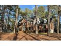 Well-maintained brick house nestled among mature trees on a spacious lot at 1809 Waddill Way, Henderson, NC 27536