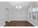 Dining room featuring gray walls, hardwood floors, and lots of natural light at 237 Sweet Violet Dr, Holly Springs, NC 27540