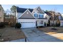 Charming two-story home featuring a two-car garage and a beautifully landscaped front yard at 237 Sweet Violet Dr, Holly Springs, NC 27540
