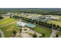 An aerial view of a community recreation center featuring a pool, walking paths, and green spaces at 248 Swann Trl, Clayton, NC 27527