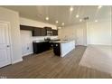 Modern kitchen with stainless steel appliances, dark wood cabinets, and granite countertops at 256 Bruce Dr, Dunn, NC 28334