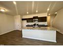 Well-lit kitchen features stainless steel appliances, a central island, and wood look floors at 256 Bruce Dr, Dunn, NC 28334