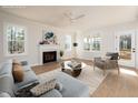 Bright living room with fireplace, large windows, hardwood floors, ceiling fan, and neutral décor at 270 Purslane Dr, Franklinton, NC 27525