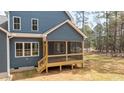 Home featuring a wood screened porch with a wooden floor and stairs leading to the backyard at 270 Purslane Dr, Franklinton, NC 27525