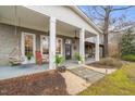 Charming front porch features stylish columns, hanging swings, and comfortable seating at 3104 Sandy Knoll Ln, Knightdale, NC 27545