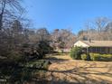 A house with a spacious backyard, surrounded by lush trees at 3501 Turnbridge Dr, Raleigh, NC 27609