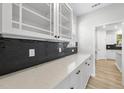 Close-up of a kitchen counter with white cabinets, quartz countertops, and a stylish black tile backsplash at 376 Buckhorn Branch Park # 38, Clayton, NC 27520