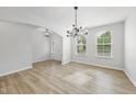 Inviting living room with natural light, featuring wood floors and modern lighting fixtures near the front entry at 376 Buckhorn Branch Park # 38, Clayton, NC 27520