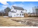 Back view of a two-story home with a covered wooden porch and spacious yard at 3812 Cobbler View Way, Fuquay Varina, NC 27526