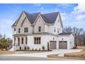 A spacious two-story home with a three-car garage and well-maintained front yard at 3812 Cobbler View Way, Fuquay Varina, NC 27526