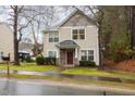 Charming two-story home featuring stone accents, a covered porch, and a well-maintained front lawn at 4102 Panther Creek Pkwy, Durham, NC 27704