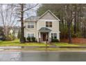 Charming two-story home featuring stone accents, a covered porch, and a well-maintained front lawn at 4102 Panther Creek Pkwy, Durham, NC 27704