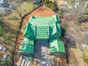 Aerial view shows green roofing in progress on a spacious home surrounded by trees at 4305 Windsor Pl, Raleigh, NC 27609