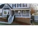 Inviting front porch with white railings and a welcoming entrance, framed by well-kept landscaping at 6309 Charmco Ct, Wake Forest, NC 27587