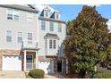 Attractive townhome exterior with stone accents, dormers, and lush landscaping at 650 Ganyard Farm Way # 13, Durham, NC 27703