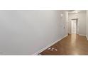 Clean hallway with hardwood flooring and neutral paint, leads to other rooms at 650 Ganyard Farm Way # 13, Durham, NC 27703