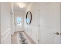 Bright entryway with decorative mirror and stylish rug at 68 Victory View Ter, Smithfield, NC 27577